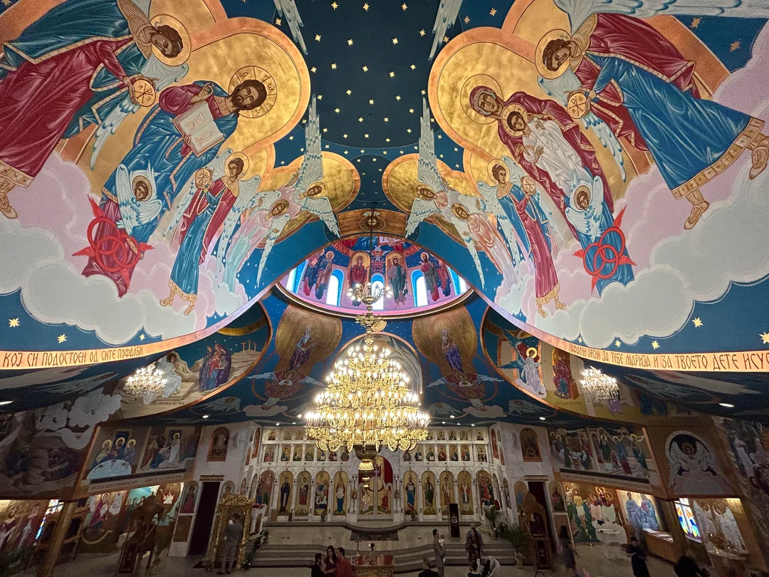Interior of an Orthodox church with iconography and chandelier